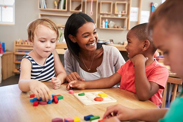 Children learn with shapes alongside their teacher